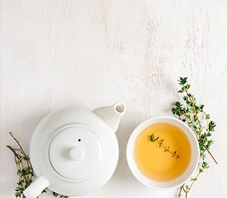 tea cup and tea pot on a wooden table
