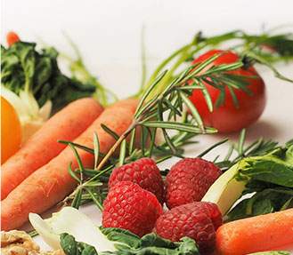 Healthy carrots, tomatoes, and raspberries